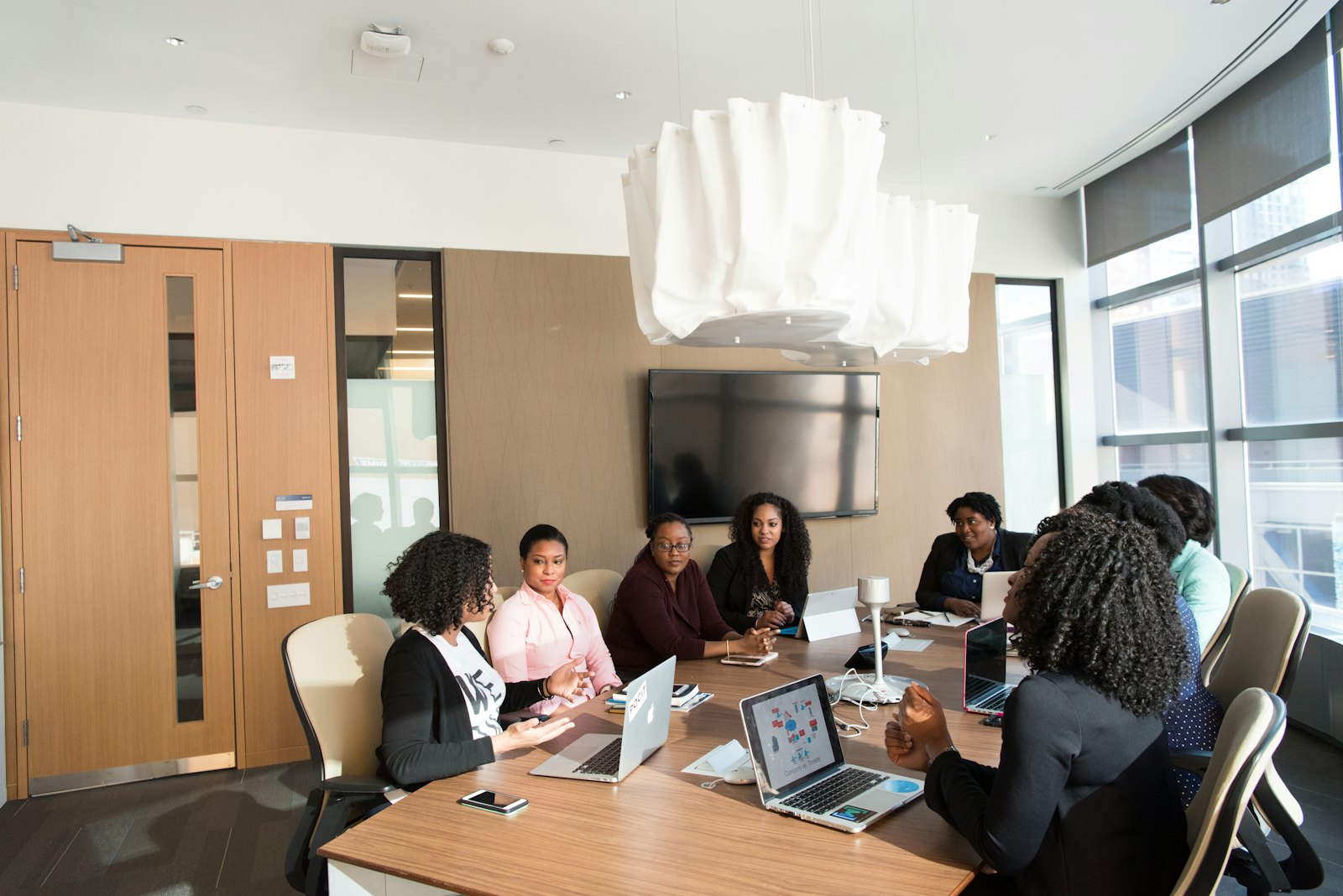 A team of professionals in a bright Nairobi boardroom reviewing figures